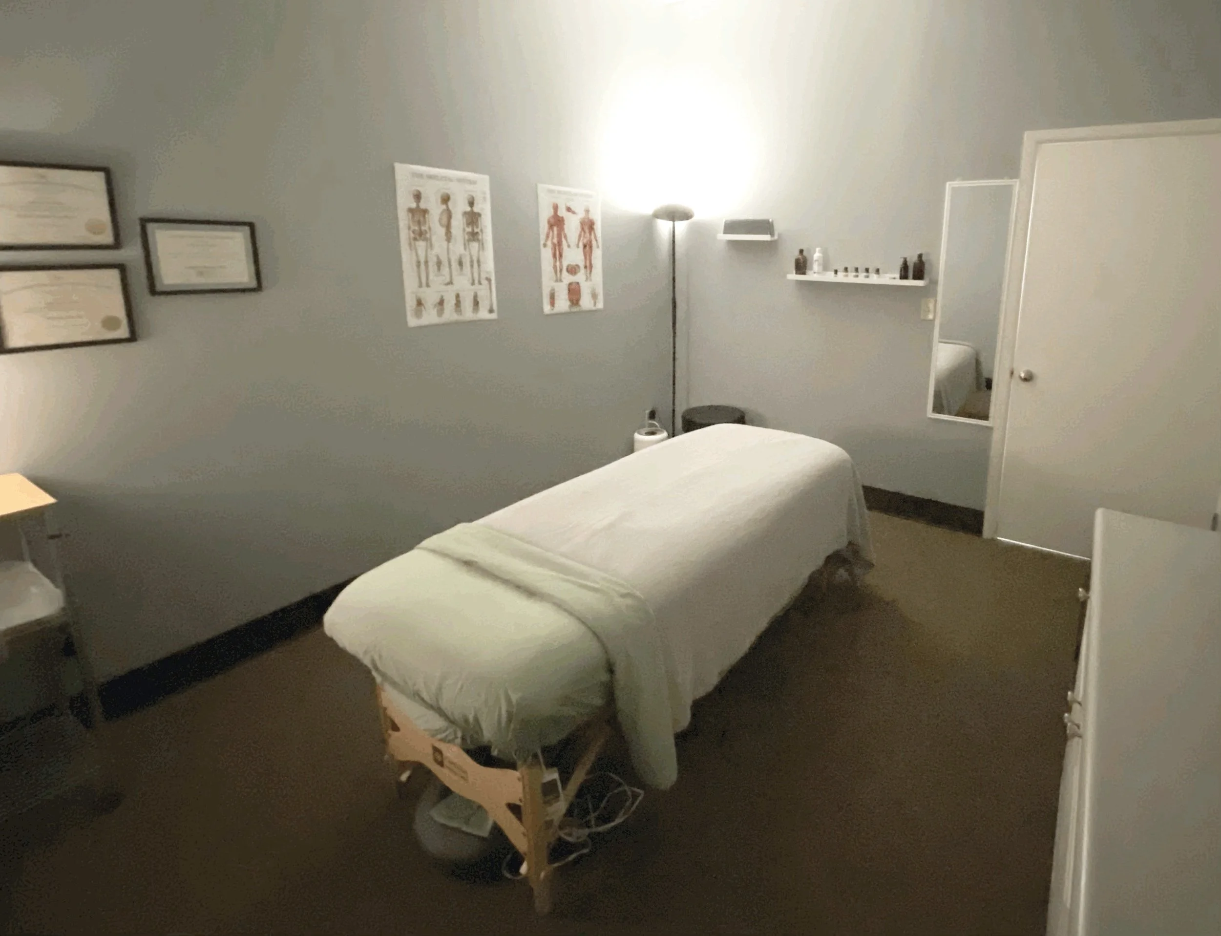 Calm treatment room at Center Point with a draped massage table